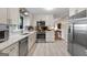 Well-equipped kitchen with stainless steel appliances, white cabinets, and a view to the dining area at 1226 Pine Knoll, Conyers, GA 30013