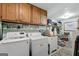 Practical laundry room with overhead cabinets and essential appliances at 1226 Pine Knoll, Conyers, GA 30013
