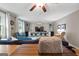 Bright living room with hardwood floors, ceiling fan, built-in shelving, and comfortable seating at 1226 Pine Knoll, Conyers, GA 30013