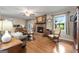 Comfortable living room with brick fireplace, hardwood floors, rocking chair, and ample natural light at 1226 Pine Knoll, Conyers, GA 30013
