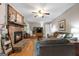 Cozy living room features a brick fireplace, hardwood floors, ceiling fan, and comfortable seating at 1226 Pine Knoll, Conyers, GA 30013