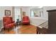 Cozy sitting area with hardwood floors, two decorative chairs, and neutral paint at 1226 Pine Knoll, Conyers, GA 30013