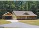 Charming one-story home boasts a spacious driveway and well-maintained lawn against a backdrop of lush trees at 518 Paynes Lake Rd, Carrollton, GA 30116