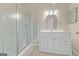 Well-lit bathroom featuring a framed glass shower with tile and a vanity with a mirror at 229 Lafayette St, Locust Grove, GA 30248