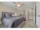 Comfortable bedroom featuring carpet, a ceiling fan, and an ensuite bathroom for added privacy and convenience at 229 Lafayette St, Locust Grove, GA 30248