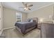 Comfortable bedroom featuring a ceiling fan, large window, and plush carpet at 229 Lafayette St, Locust Grove, GA 30248