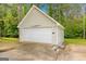 Detached garage featuring white siding, a single car door, and an airplane propeller as a decorative element at 229 Lafayette St, Locust Grove, GA 30248