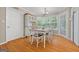 Bright dining area featuring hardwood floors, white wooden table and chairs, with natural light from a large window at 229 Lafayette St, Locust Grove, GA 30248