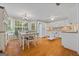 Bright kitchen featuring white cabinets, hardwood floors, and a cozy breakfast nook with large windows at 229 Lafayette St, Locust Grove, GA 30248