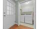 Laundry room features a washer, dryer, a utility sink, and shelving, for efficient laundry at 229 Lafayette St, Locust Grove, GA 30248