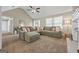 Bright living room featuring vaulted ceilings, a large sectional sofa, and neutral décor for a welcoming atmosphere at 229 Lafayette St, Locust Grove, GA 30248