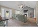 Cozy living room with a plush sofa, fireplace, vaulted ceiling, and ample natural light from large windows at 229 Lafayette St, Locust Grove, GA 30248