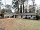 Charming single-story home with a covered carport and well-maintained front yard at 310 Flagstone Sw Dr, Atlanta, GA 30331