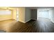 Open-concept living space featuring hardwood flooring with a view to the kitchen at 310 Flagstone Sw Dr, Atlanta, GA 30331
