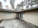 Back patio with tan siding, surrounded by trees at 310 Flagstone Sw Dr, Atlanta, GA 30331