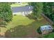Aerial view showcasing the backyard, patio, storage shed, and expansive lawn at 3005 Ryan Rd, Locust Grove, GA 30248