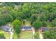 Aerial view of a home nestled amongst mature trees and a long driveway at 3005 Ryan Rd, Locust Grove, GA 30248