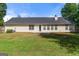 Expansive backyard featuring a well-maintained lawn and an outdoor patio area for relaxing and entertaining at 3005 Ryan Rd, Locust Grove, GA 30248