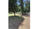 Spacious backyard featuring a wooden fence, mature trees, and a mix of grassy and shaded areas at 3005 Ryan Rd, Locust Grove, GA 30248