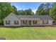 Charming single-story home featuring a welcoming front porch and well-maintained lawn and mature landscaping at 3005 Ryan Rd, Locust Grove, GA 30248