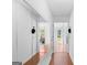 Bright hallway featuring hardwood floors and large mirrored closet, and views into other rooms at 3005 Ryan Rd, Locust Grove, GA 30248