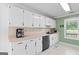 Well-lit kitchen with white cabinets, modern appliances, and ample counter space for meal preparation at 3005 Ryan Rd, Locust Grove, GA 30248