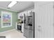 Efficient kitchen with stainless steel appliances, white cabinets, and a bright window at 3005 Ryan Rd, Locust Grove, GA 30248