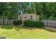 Backyard featuring a storage shed, garden, lush grass, and fencing to secure the perimeter at 3005 Ryan Rd, Locust Grove, GA 30248
