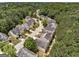 A high-angle showcases neatly arranged homes in a well-maintained community, embraced by a canopy of verdant trees at 737 Shadow Lake Dr, Lithonia, GA 30058