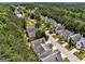 An aerial shot showcases houses with well-kept lawns, nestled within a community bordered by dense trees and greenery at 737 Shadow Lake Dr, Lithonia, GA 30058