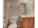 Compact bathroom with a toilet, vanity, mirror and a shower-tub combo at 737 Shadow Lake Dr, Lithonia, GA 30058
