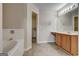 Bright bathroom featuring a soaking tub, vanity, and walk-in closet at 737 Shadow Lake Dr, Lithonia, GA 30058