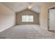 Large primary bedroom with vaulted ceilings, neutral walls, carpet, and a window at 737 Shadow Lake Dr, Lithonia, GA 30058
