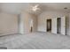 Spacious primary bedroom with a ceiling fan, en-suite bathroom, and walk-in closet at 737 Shadow Lake Dr, Lithonia, GA 30058