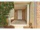 Welcoming front porch with brick accents and a classic white front door at 737 Shadow Lake Dr, Lithonia, GA 30058