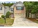 Charming brick-front home with a two-car garage and well-maintained lawn in a residential neighborhood at 737 Shadow Lake Dr, Lithonia, GA 30058