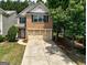 Charming brick front exterior featuring a two-car garage and well-manicured landscaping at 737 Shadow Lake Dr, Lithonia, GA 30058