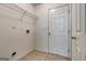 Utility room with tile flooring, storage shelves, washer hook up, and exterior access at 737 Shadow Lake Dr, Lithonia, GA 30058