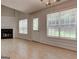 Open living room area with natural light, fireplace and an easy access to outdoor through the back door at 737 Shadow Lake Dr, Lithonia, GA 30058