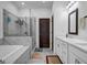 Modern bathroom featuring a soaking tub, glass-enclosed shower, and dual sink vanity at 4565 Sims Park Overlook, Suwanee, GA 30024