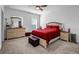 Cozy bedroom with plush carpet, a comfortable bed, and ample natural light at 4565 Sims Park Overlook, Suwanee, GA 30024
