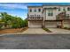 Exterior view of townhome garages and a private deck with lawn at 4565 Sims Park Overlook, Suwanee, GA 30024