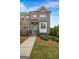 Beautiful brick townhome with a manicured lawn and a stylish blue front door at 4565 Sims Park Overlook, Suwanee, GA 30024