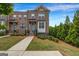 Charming brick townhome featuring well-maintained landscaping and a welcoming entrance at 4565 Sims Park Overlook, Suwanee, GA 30024