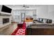 Cozy living room featuring a fireplace, comfortable seating, and natural light from large windows at 4565 Sims Park Overlook, Suwanee, GA 30024