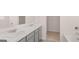 Bathroom featuring double sinks with marble countertops and access to walk-in closet at 162 Aster Ave, Locust Grove, GA 30248