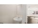 Powder room features a pedestal sink and mirror with a view of the main living area at 162 Aster Ave, Locust Grove, GA 30248
