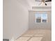 Bright bedroom featuring a ceiling fan, neutral carpet, and large window at 162 Aster Ave, Locust Grove, GA 30248