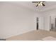 Light-filled bedroom with neutral carpet and fan, adjoins the kitchen and bathroom at 162 Aster Ave, Locust Grove, GA 30248