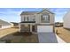 Two-story home featuring a two-car garage, brick accents, and a well-manicured lawn at 162 Aster Ave, Locust Grove, GA 30248